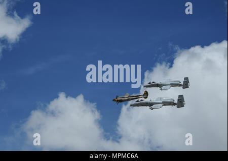 Two U.S. Air Force A-10C Thunderbolt IIs, assigned to the 354th Fighter Squadron and a part of the A-10 West Heritage Flight Team, and a P-38 Lightning fly in formation during the Los Angeles County Air Show in Lancaster, Calif., March 25, 2017. This is the team’s first air show performance after nearly five years of disbandment. (U.S. Air Force photo by Airman 1st Class Mya M. Crosby) Stock Photo