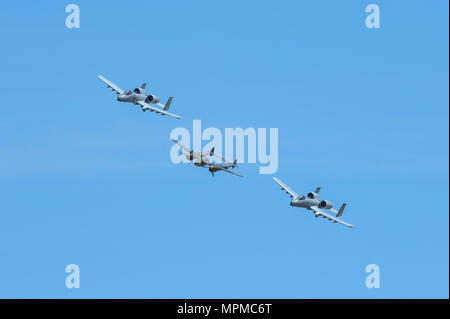 Two U.S. Air Force A-10C Thunderbolt IIs, assigned to the 354th Fighter Squadron and a part of the A-10 West Heritage Flight Team, and a P-38 Lightning fly in formation during the Los Angeles County Air Show in Lancaster, Calif., March 26, 2017. This is the team’s first air show performance after nearly five years of disbandment. (U.S. Air Force photo by Airman 1st Class Mya M. Crosby) Stock Photo