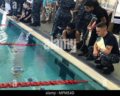 Recruiters from Navy Recruiting District Houston assist students participating in the 2017 regional SeaPerch competition at Manvel High School, Houston, Texas, on March 25, 2017. More than 40 recruiters volunteered to support the seven teams advancing to the national SeaPerch competition, helping students learn robotics design, engineering fundamentals, STEM skills, teamwork, and problem-solving while fostering interest in naval careers and scholarship opportunities. Stock Photo