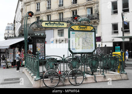 Paris Metro entrance outside Cadet Station with Metropolitan sign, Cadet sign and map in Paris France Europe EU  KATHY DEWITT Stock Photo