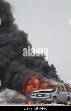 Civilian and military personnel from Kuwait, Saudi Arabia and the U.S. conducted counterterrorism drills as part of Eagle Resolve 2017 near Kuwait International Airport, March 28, 2017. Urban warfare specialists conducted search and rescue operations and responded to a mock vehicle explosion (pictured). Since 1999, Eagle Resolve - involving over 1,000 U.S. military personnel - has become the premier multi-national exercise between U.S. and Gulf Cooperation Council nations to collectively address the regional challenges in a low-risk setting. (Photo by U.S. Army Staff Sgt. Francis O’Brien) Stock Photo