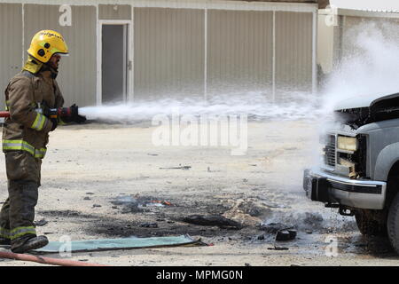 Civilian and military personnel from Kuwait, Saudi Arabia and the U.S. conducted counterterrorism drills as part of Eagle Resolve 2017 near Kuwait International Airport, March 28, 2017. Urban warfare specialists conducted search and rescue operations and responded to a mock vehicle explosion. A Kuwaiti firefighter (pictured) extinguishes the fire. Since 1999, Eagle Resolve - involving over 1,000 U.S. military personnel - has become the premier multi-national exercise between U.S. and Gulf Cooperation Council nations to collectively address the regional challenges in a low-risk setting. (Photo  Stock Photo