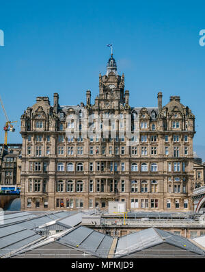 Balmoral Hotel, Rocco Forte 5 Star luxury hotel, Princes Street, Edinburgh, Scotland, UK with workmanin orange abseiling Stock Photo