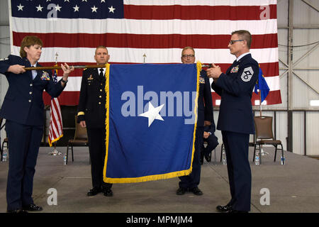 SIOUX FALLS, S.D. – U.S. Army Maj. Gen. Timothy A. Reisch, Adjutant General for South Dakota, presented a flag to U.S. Air Force Brig. Gen. Joel E. DeGroot, Assistant Adjutant General for Air, HQ SDANG during a promotion and transfer of authority ceremony at Joe Foss Field, S.D., April 1, 2017.  DeGroot previously served as the 114th Maintenance Group commander. (U.S. Air National Guard photo by Technical Sgt. Luke Olson/Released) Stock Photo