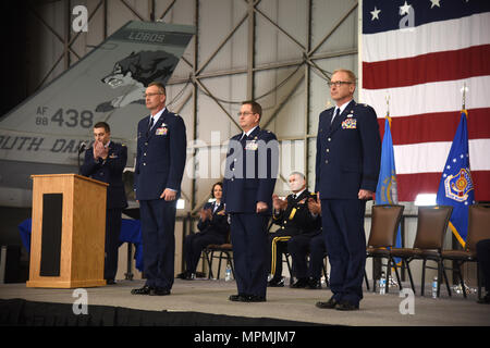 SIOUX FALLS, S.D. - Col. Nate Alholinna, 114th Fighter Wing commander, Lt. Col. Kevin Curley, 114th Maintenance Group commander, and Brig. Gen. Joel DeGroot, outgoing 114th Maintenance Group commander and newly appointed Assistant Adjutant General for Air, stand ready for the ceremonial change of command during an event held April 1, 2017.  Curley assumed command of the 480 Airmen in the maintenance group which oversees 22 assigned shops and 30 Air Force Specialty Codes.  (U.S. Air National Guard photo by Staff Sgt. Duane Duimstra/Released) Stock Photo