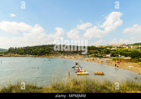 Rab Island, Primorje-Gorski Kotar / Croatia - 28 08 2014: View on a beach on a rab island with few tourists, Adriatic sea and mountains in distance Stock Photo