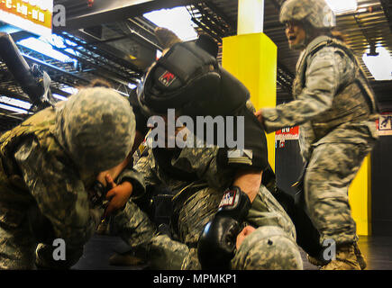 Three Fort Bragg Soldiers and an Instructor (center) at the XVIII Airborne Corps and Fort Bragg Combatives School practice Modern Army Combatives at Fort Bragg N.C., Feb. 10, 2017. The students were taking the final test of their training by withstanding armored assailants in an urban enviorment. (U.S. Army photo by Pfc. Hubert D. Delany III/ 22nd Mobile Public Affairs Detachment) Stock Photo