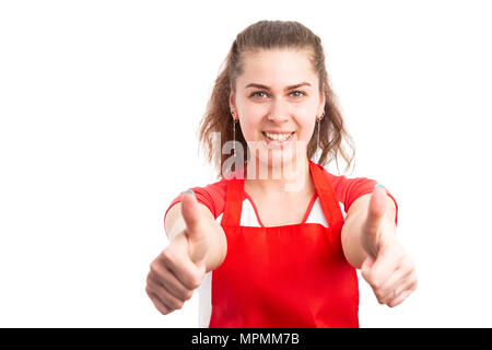 Young woman supermarket employee showing thumbs up like gesture as happy retailer concept isolated on white background Stock Photo
