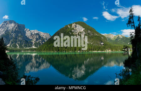 Braies lake in a clear day of summer season with mountains and blue sky in background, Dolomites - Italy Stock Photo