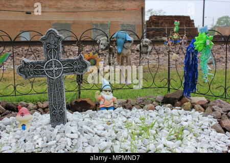 Roadside memorial to a lost loved one includes angels, crosses, and knick knacks. Stock Photo