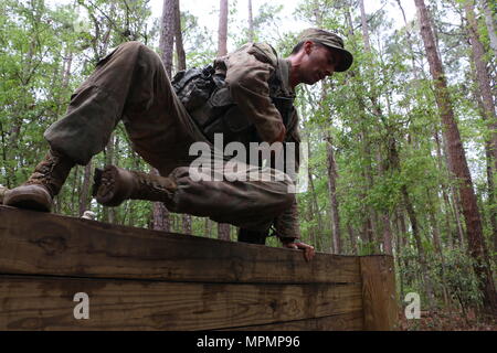 Sgt. Blake Reyna, team leader with Alpha Troop, 6th Squadron, 8th Cavalry Regiment, 2nd Infantry Brigade Combat Team, 3rd Infantry Division, goes over a wall during the 2017 division level Gainey Cup competition March 30, 2017 at Fort Stewart, Ga. Soldiers of 3rd ID participated in a selection process to determine which squad would advance to this year's biennial Gainey Cup competition at Fort Benning, Ga. (U.S. Army photo by Sgt. Robert Harris/ Released)