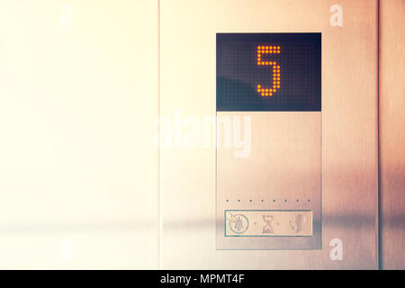 Monitor show number five floor in metal modern elevator Stock Photo