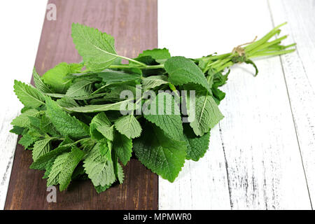 bunch of lemon balm on wooden background Stock Photo
