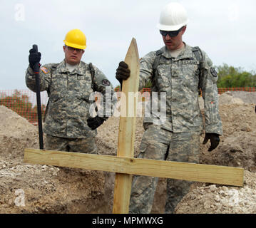 U.S. Army Sgt. Ramon Firestone and Pfc. Dylan Berger, both engineers with the 672nd Engineer Company, an Army Reserve unit from Missoula, Montana, ensures that the ground is level for a construction project at Double Head Cabbage, Belize, March 31, 2017. . Soldiers with the 672nd are building a medical clinic as a part of Beyond the Horizon 2017, a partnership exercise between the U.S. military, Belize Defense Force and multiple Belize government agencies that will consist of four construction projects and three medical service events in the districts of Belize, Cayo and Stann Creek. (U.S. Arm Stock Photo