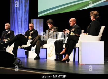 NATIONAL HARBOR, Md. (Apr. 04, 2017). Vice Adm. Mike Gilday, commander U.S. Fleet Cyber Command/U.S. 10th Fleet, speaks during the “Cyber Operations in Sea Services” panel held at the 2017 Sea-Air-Space Exposition. Joining him on the panel, from left, are: Rear Adm. Kevin Lunday, commander U.S. Coast Guard Cyber Command and assistant commandant for C4IT; Rear Adm. Timothy White, commander, Cyber, National Mission Force; Maj. Gen. Lori Reynolds, commander, Marine Forces Cyber Command; and moderator Vice Adm. Jan Tighe, deputy chief of naval operations for Information Warfare and director of nav Stock Photo