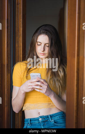 Portrait of young woman using smartphone Stock Photo
