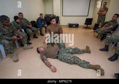 KUALA LUMPUR, Malaysia (April 11, 2017) Hospital Corpsman 2nd Class(FMF) Gustavo Llerenas and Hospital Corpsman 2nd Class(FMF) Nilo Deguiera perform a demonstration for tactical combat casualty care (TCCC) during a Pacific Partnership 2017 medical subject matter exchange event at Hospital Angatan Tentera Tuanka Mizan. Pacific Partnership is the largest annual multilateral humanitarian assistance and disaster relief preparedness mission conducted in the Indo-Asia-Pacific and aims to enhance regional coordination in areas such as medical readiness and preparedness for manmade and natural disaste Stock Photo