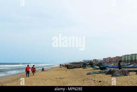 Fishermen and fishing boats on Marina beach in Chennai, India. Stock Photo