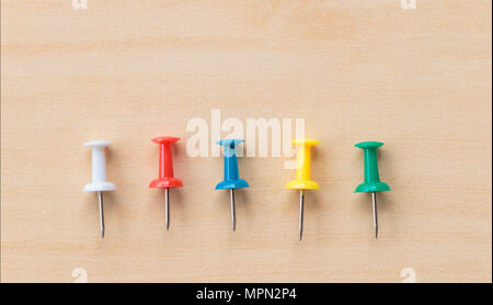 Colorful pin put on wooden table top background Stock Photo