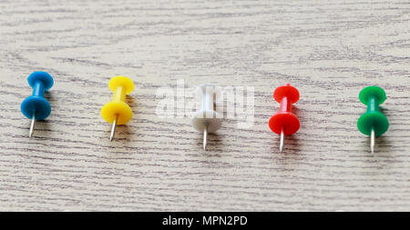 Colorful pin put on wooden table top background Stock Photo