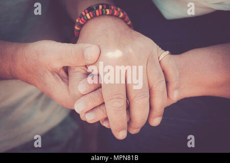 always tegether concept for a pair of elderly senior hands touching and staying together. Love moment for a life together