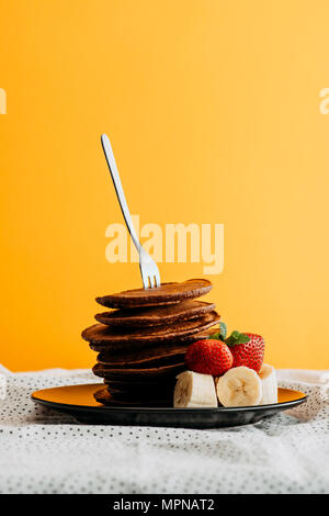 Plate With Yummy Banana Pancakes On Kitchen Table Stock Photo - Alamy