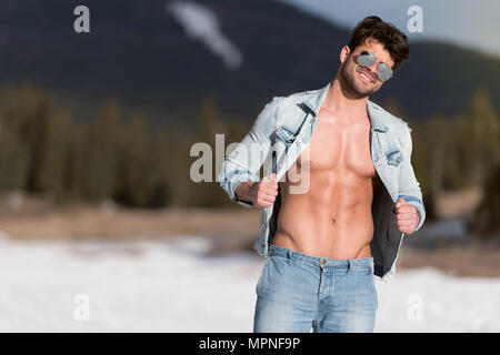 fitness model posing, muscular abs chest, upper body shot, one young adult  Caucasian man, black background, studio, jeans, leather jacket Stock Photo  - Alamy