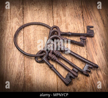 Old rusty keys on wooden  background Stock Photo