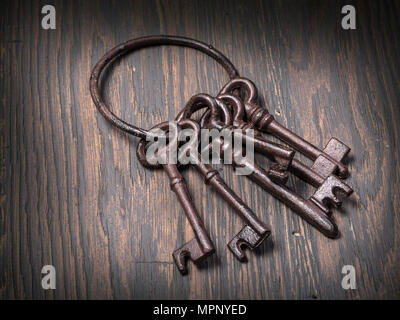 Old rusty keys on wooden  background Stock Photo
