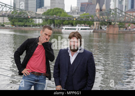 Frankfurt, Germany. 24th May 2018. Actors Wanja Mues (left) and Antoine Monot, Jr. (right) pose on the gangway of the houseboat that is owned by Mues' character Leo in the TV show. 4 new episodes of the relaunch of the long running TV series 'Ein Fall fuer zwei’ (A case for two) are being filmed in Frankfurt for the German state TV broadcaster ZDF (Zweites Deutsches Fernsehen). It stars Antoine Monot, Jr. as defence attorney Benjamin ‘Benni’ Hornberg and Wanja Mues as private investigator Leo Oswald. The episodes are directed by Thomas Nennstiel. The episodes are set to air in October. Stock Photo