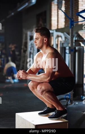 Man doing exercises at gym Stock Photo