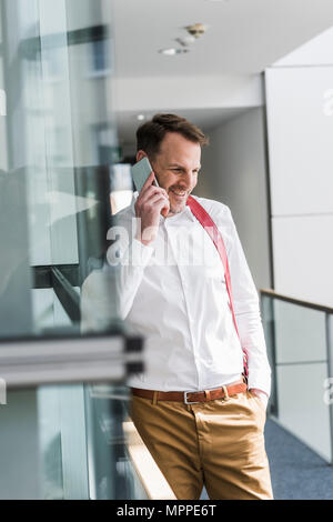 Smiling businessman talking on cell phone Stock Photo