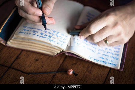 Taking notes in personal journal Stock Photo