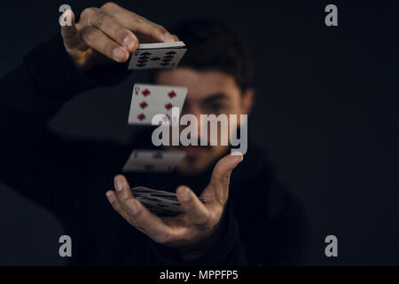 Magician conjuring with playing cards, close-up Stock Photo