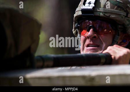 U.S. Army Capt. Timothy Cox, 3rd Chemical Brigade, Maneuver Support Center of Excellence, carries a simulated patient over an obstacle  during the Best Ranger Competition 2017 at Ft. Benning, Ga., April 8, 2017. The 34th annual David E. Grange Jr. Best Ranger Competition 2017 is a three-day event consisting of challenges to test competitor's physical, mental, and technical capabilities. (U.S. Air Force photo by Airman 1st Class Nicholas Dutton) Stock Photo