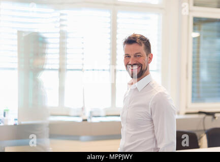 Portrait of a successful businessman standing in office Stock Photo