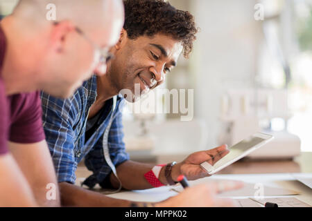 Two fashion designers using tablet in studio Stock Photo