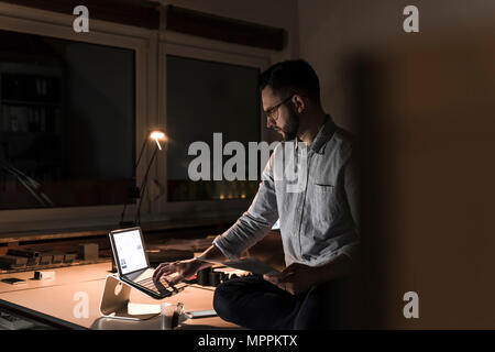 Businessman working late in office Stock Photo