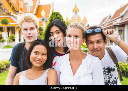 Thailand, Bangkok, group picture of five friends visiting temple complex Stock Photo