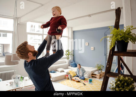 Father and baby son having fun together at home