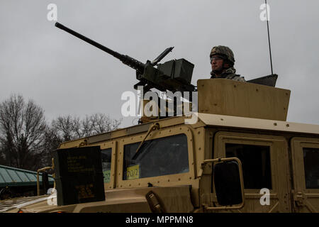 A tactical vehicle mounted with an M2 .50 caliber machine gun receives ammunition in preparation for  a live fire exercise at Range 26 on Fort McCoy, Wis., during Operation Cold Steel, April 03, 2017. Operation Cold Steel is the U.S. Army Reserve’s crew-served weapons qualification and validation exercise to ensure that America’s Army Reserve units and Soldiers are trained and ready to deploy on short-notice and bring combat-ready, lethal firepower in support of the Army and our joint partners anywhere in the world. (U.S. Army Reserve photo by Spc. Jeremiah Woods, 358th Public Affairs Detachme Stock Photo