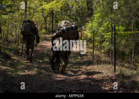 U.S. Army Capt. Timothy Cox and 1st Lt. Andy Harvey, 3rd Chemical Brigade Rangers, march to their next event during the Best Ranger Competition 2017 in Fort Benning, Ga., April 9, 2017. The 34th annual David E. Grange Jr. Best Ranger Competition 2017 is a three-day event consisting of challenges to test competitor's physical, mental, and technical capabilities. (U.S. Air Force photo by Staff Sgt. Marianique Santos) Stock Photo