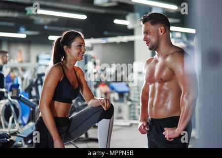 Smiling man and woman talking at the gym Stock Photo