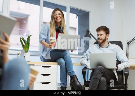 Coworkers in the office having an informal meeting Stock Photo