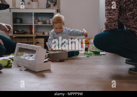 Christmas time, boy unpacking presents Stock Photo