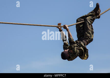 U.S. Army Ranger Capt. Timothy Cox, 3rd Chemical Brigade, crosses an obstacle at the Combat Water Survival Assessment during the 34th annual David E. Grange Jr. Best Ranger Competition at Ft. Benning, Ga., Apr. 9, 2017. The Best Ranger competition is a three-day event consisting of challenges to test competitor's physical, mental, and technical capabilities, and places the military's best two-man Ranger teams against each other to compete for the title of Best Ranger. (U.S. Army photo by Staff Sgt. Justin P. Morelli / Released) Stock Photo