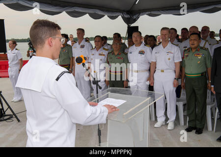 170410-N-SF984-005   PORT KLANG, Malaysia (April 10, 2017) Musician 2nd Class Holden Moyer of the U.S. 7th Fleet Band sings the Malaysian and United States national anthems during the opening ceremony for Pacific Partnership 2017 Malaysia on the pier. Pacific Partnership is the largest annual multilateral humanitarian assistance and disaster relief preparedness mission conducted in the Indo-Asia-Pacific and aims to enhance regional coordination in areas such as medical readiness and preparedness for manmade and natural disasters. (U.S. Navy photo by Mass Communication Specialist 2nd Class Chel Stock Photo