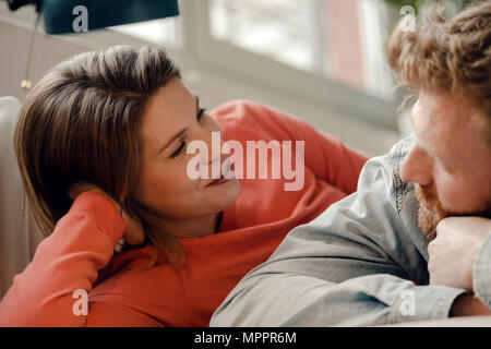 Happy couple at home talking and listening to each other Stock Photo