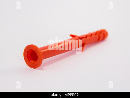 One plastic orange dowel on white background Stock Photo