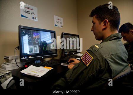 U.S. Naval officers assigned to the Basic Flight Training Course, Training Air Wing Four, practice on a flight management system at Naval Air Station Corpus Christi, Texas, March 20, 2017. The mission of Training Air Wing Four is to provide basic flight training as well as intermediate and advanced flight training using multi-engine aircraft. (U.S. Marine Corps photo by Lance Cpl. Jose Villalobosrocha) Stock Photo